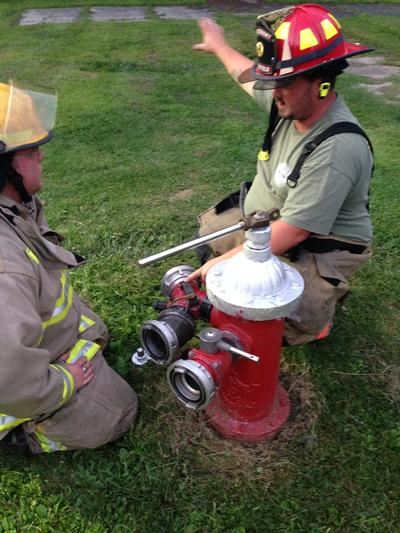 Dressing a Hydrant - Lt. Meehan shows PFF Mathey how to set up a hydrant for water supply. Both members have since moved and joined other departments since this photo was taken. 